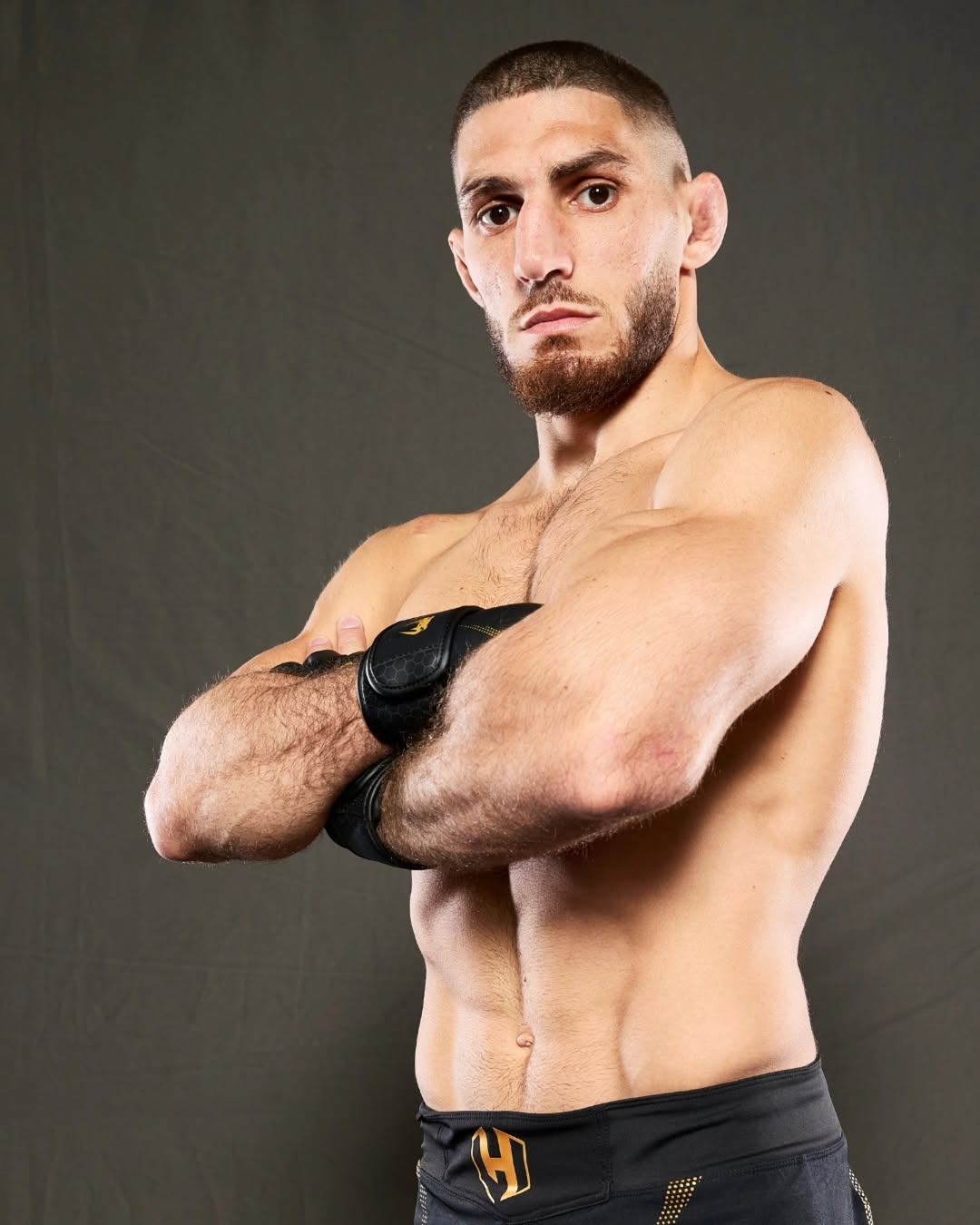 Michael Aljarouj portrait arms crossed MMA gloves