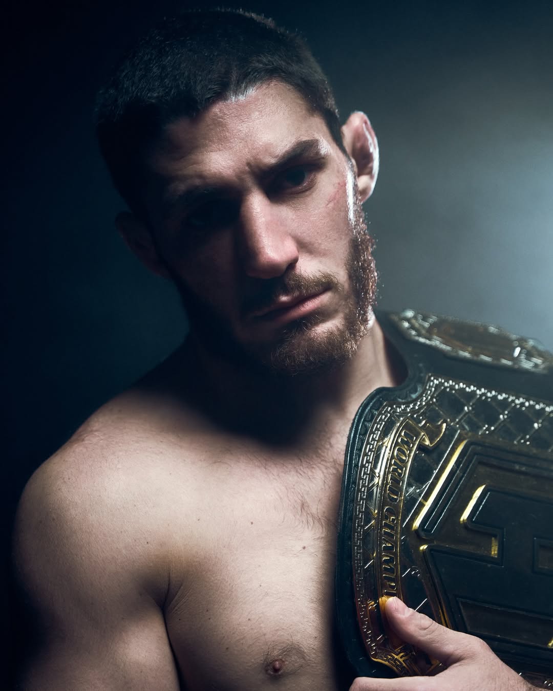 Michael Aljarouj, MMA champion, dark portrait with belt